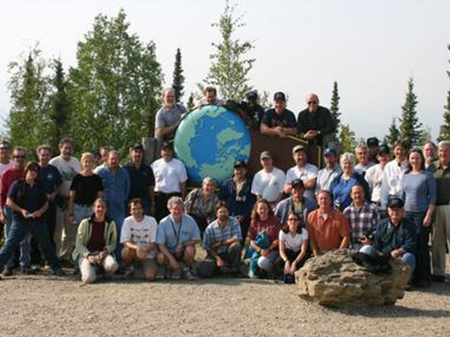 Coordinating Committee meeting participants posed for photos at the Arctic Circle. Photo courtesy of: Nancy Grimm.