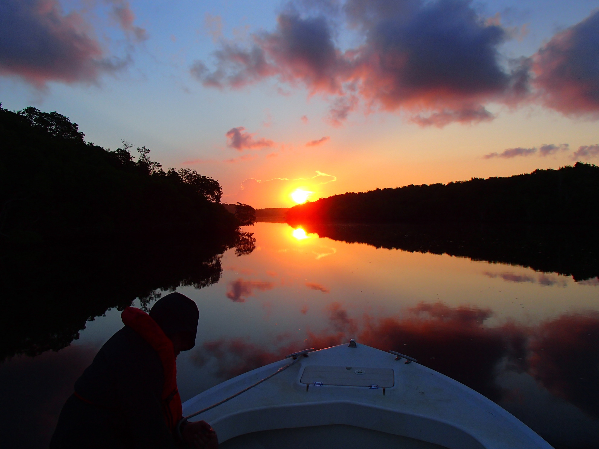 An FCE researcher looks out on a sunset over the Everglades