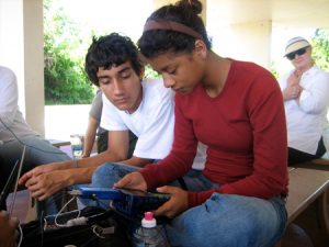 Timothy Hidalgo-Vega and Vanessa Castellaños from the Felix Varela Senior High School Global Studies MAGNET testing equipment before collecting data under the watchful eye of Research Experience for Teacher fellow, Ms. Catherine Laroche