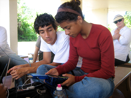 Timothy Hidalgo-Vega and Vanessa Castellaños from the Felix Varela Senior High School Global Studies MAGNET testing equipment before collecting data under the watchful eye of Research Experience for Teacher fellow, Ms. Catherine Laroche