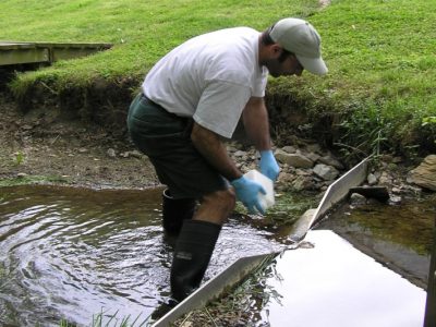 BES LTER scientist sampling water at a long-term suburban watershed site in Baltimore County, MD.