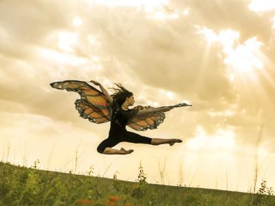 Winged dancer leaps over a field of milkweed