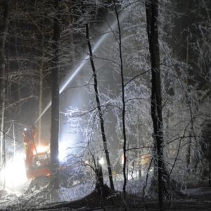fire hose coating Hubbard Brook forest with ice at night