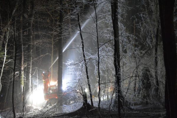 fire hose coating Hubbard Brook forest with ice at night