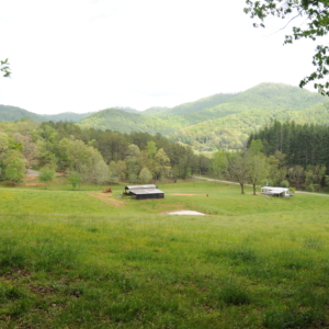 An old barn in the distance against the backdrop of the Appalachian foothills