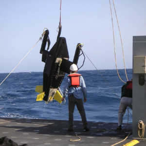 hauling a large instrument aboard ship