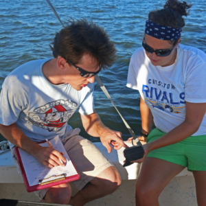 Research Technician Tim Montgomery records water quality data with a teacher during the GCE schoolyard summer workshop.