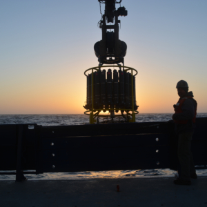 CTD instrument on ship with sunset in background