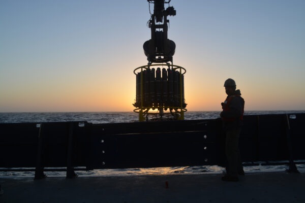 CTD instrument on ship with sunset in background