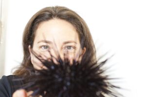 closeup of Dr. Gretchen Hofmann holding out a sea urchin