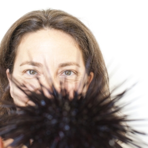 closeup of Dr. Gretchen Hofmann holding out a sea urchin