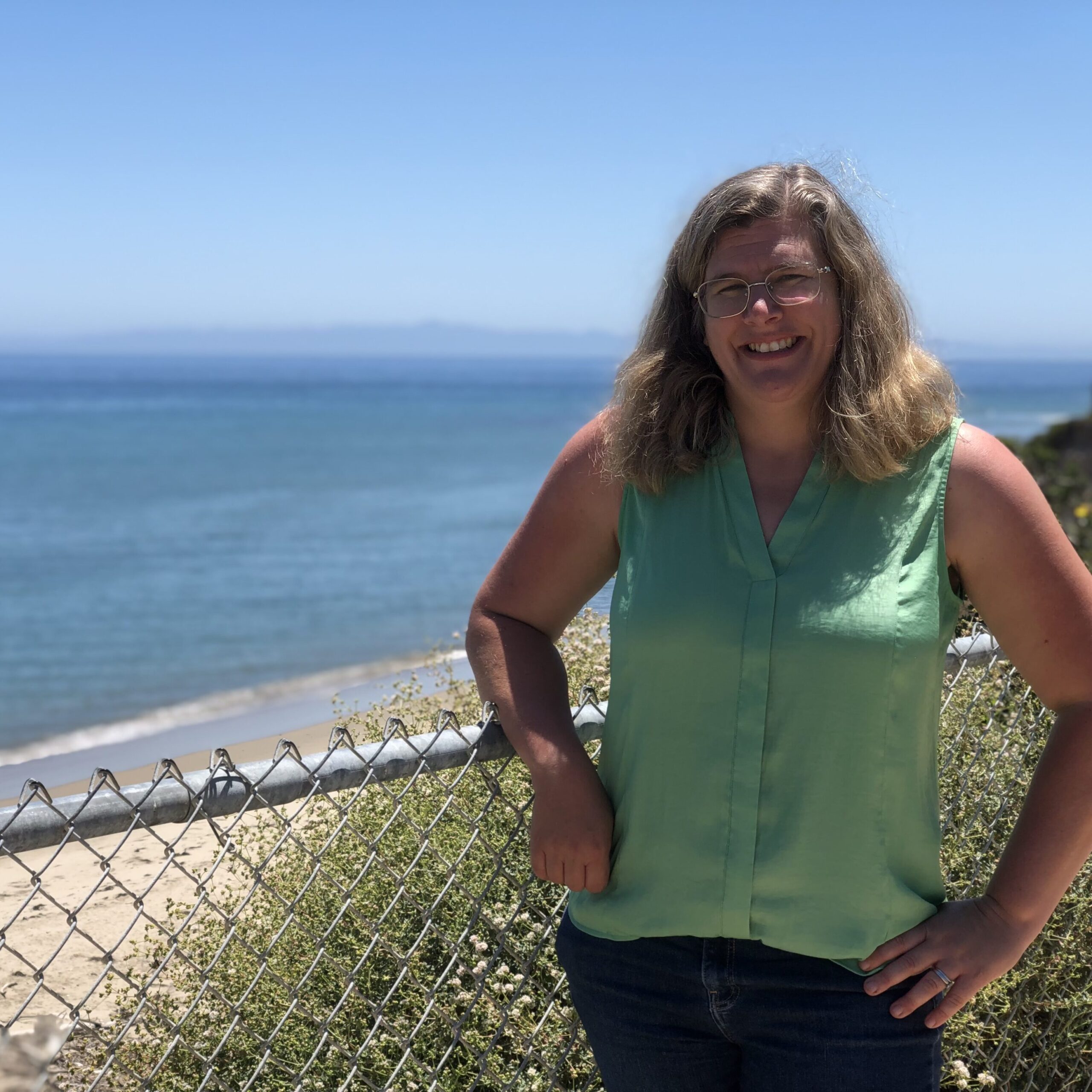 Smiling woman overlooking the beach