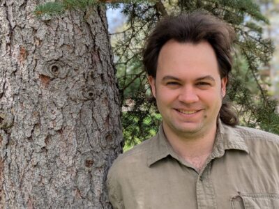 Cameron Clay, leaning against a tree