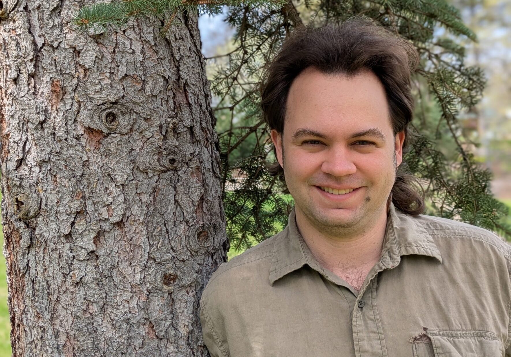 Cameron Clay, leaning against a tree