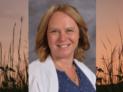 headshot of a smiling woman with shoulder-length strawberry-blond hair over an image of prairie grasses in the sunrise