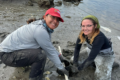 two young scientists sampling in a marsh