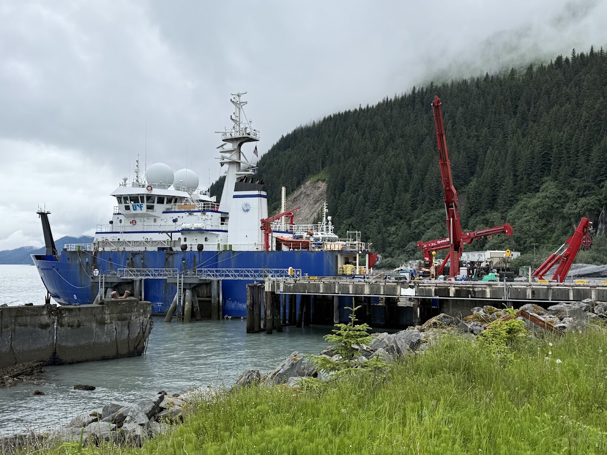 An oceanographic research vessel, the RV Sikuliaq, sitting at a dock
